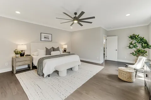 a white room with a sink and a large mirror