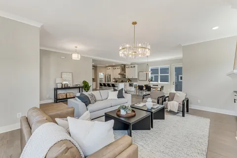 a living room with furniture chandelier and a chandelier