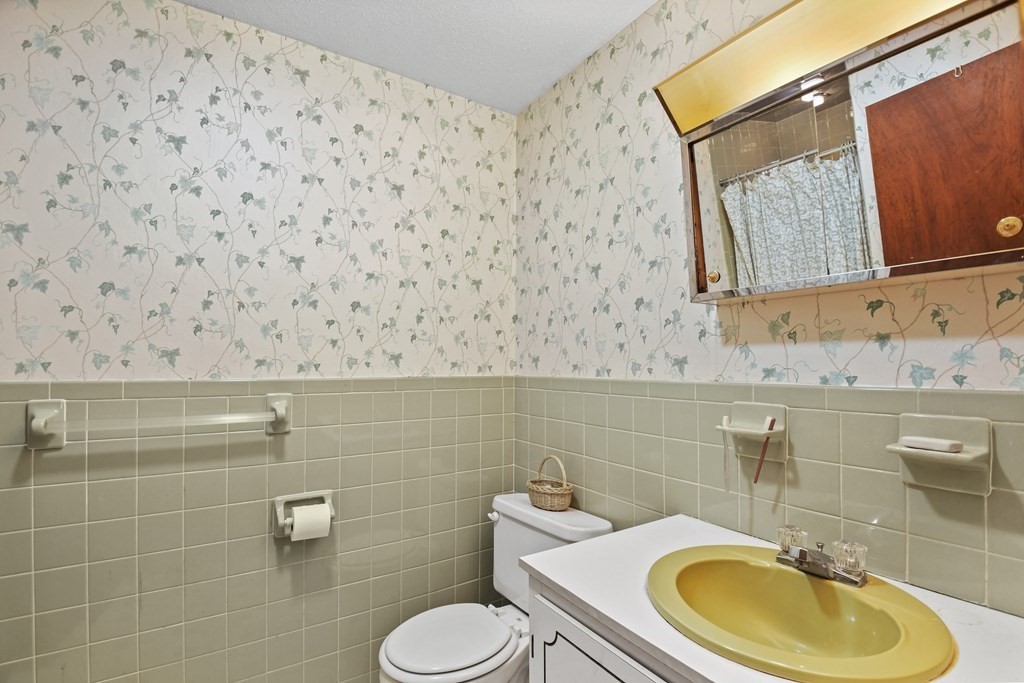 162 Cedric Road Barnstable, MA 02632 - Photo 15 of 29 a bathroom with a sink a toilet and a mirror