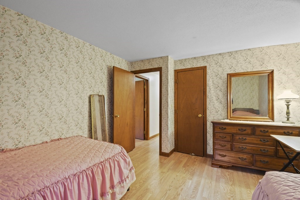 162 Cedric Road Barnstable, MA 02632 - Photo 20 of 29 a bedroom with a bed and wooden floor