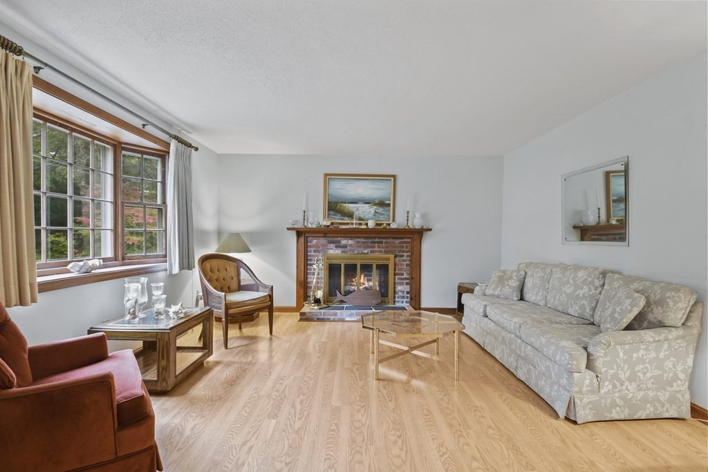 162 Cedric Road Barnstable, MA 02632 - Photo 4 of 29 a living room with furniture and a fireplace