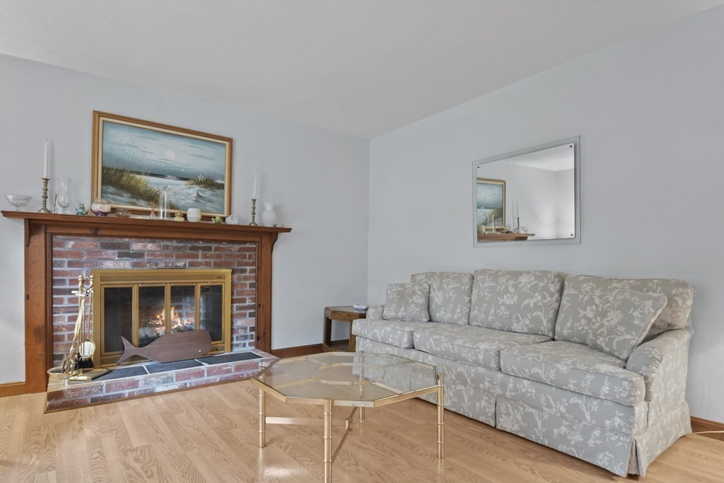 162 Cedric Road Barnstable, MA 02632 - Photo 5 of 29 a living room with furniture and a fireplace