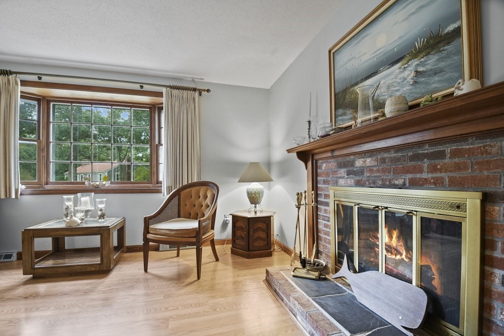 162 Cedric Road Barnstable, MA 02632 - Photo 7 of 29 a living room with furniture and a fireplace