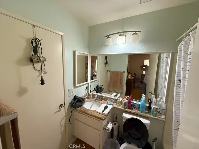 a bathroom with a sink mirror and shower