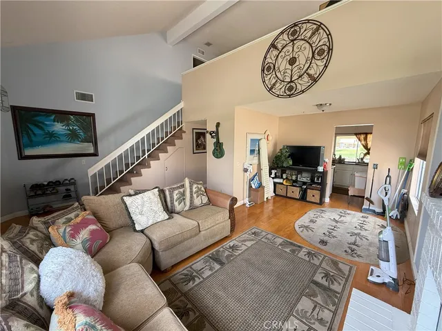 a living room with furniture a flat screen tv and a wall