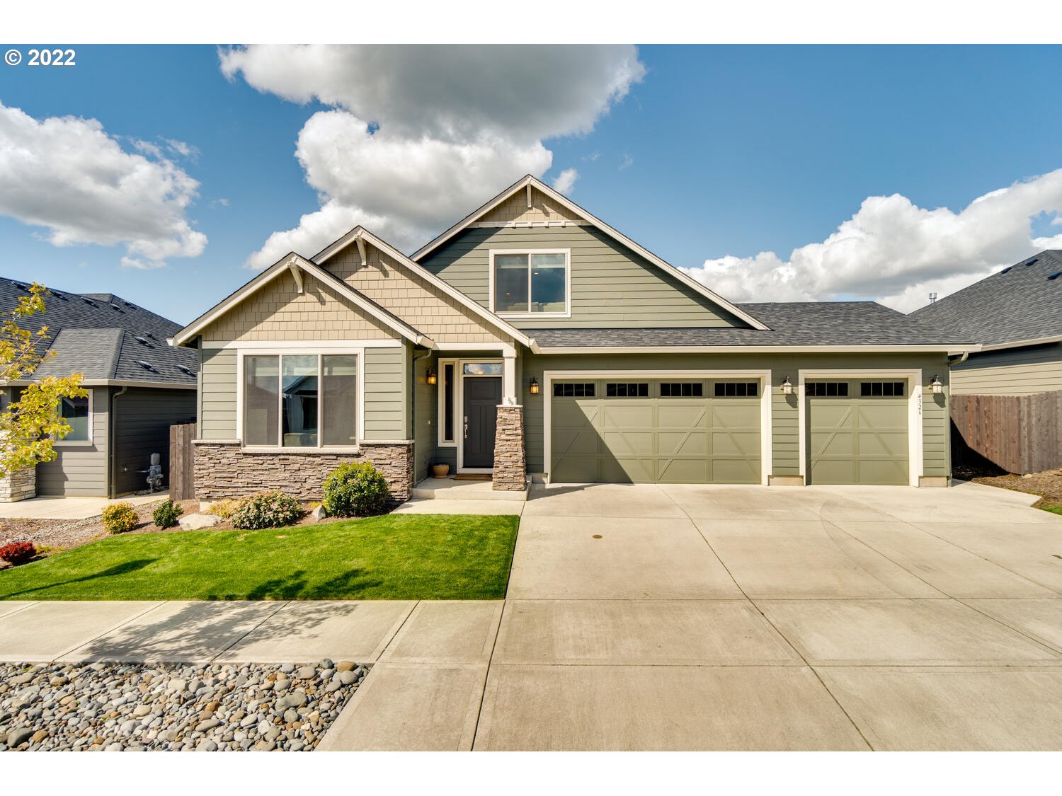 4326 South 11th Way Ridgefield, WA 98642 - Photo 1 of 26 a front view of a house with a garden and yard