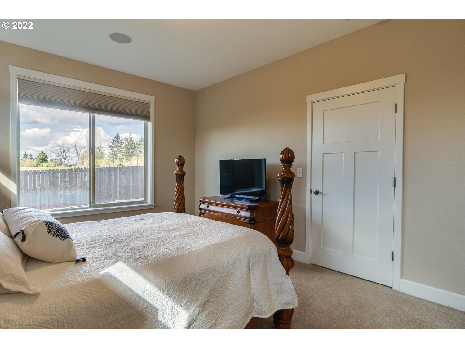 4326 South 11th Way Ridgefield, WA 98642 - Photo 17 of 26 a bedroom with a bed and large windows
