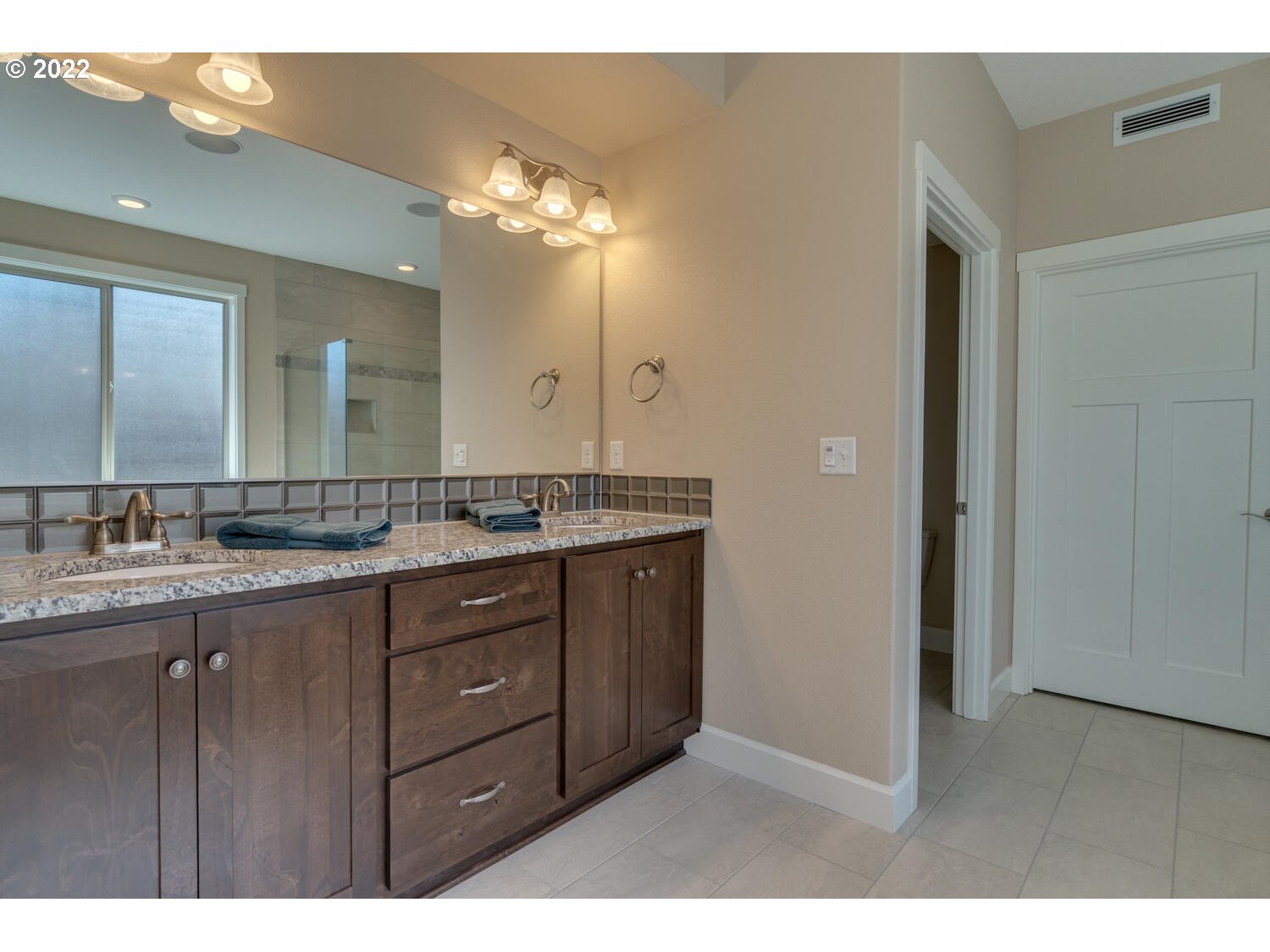4326 South 11th Way Ridgefield, WA 98642 - Photo 19 of 26 a bathroom with a granite countertop sink a large mirror and a