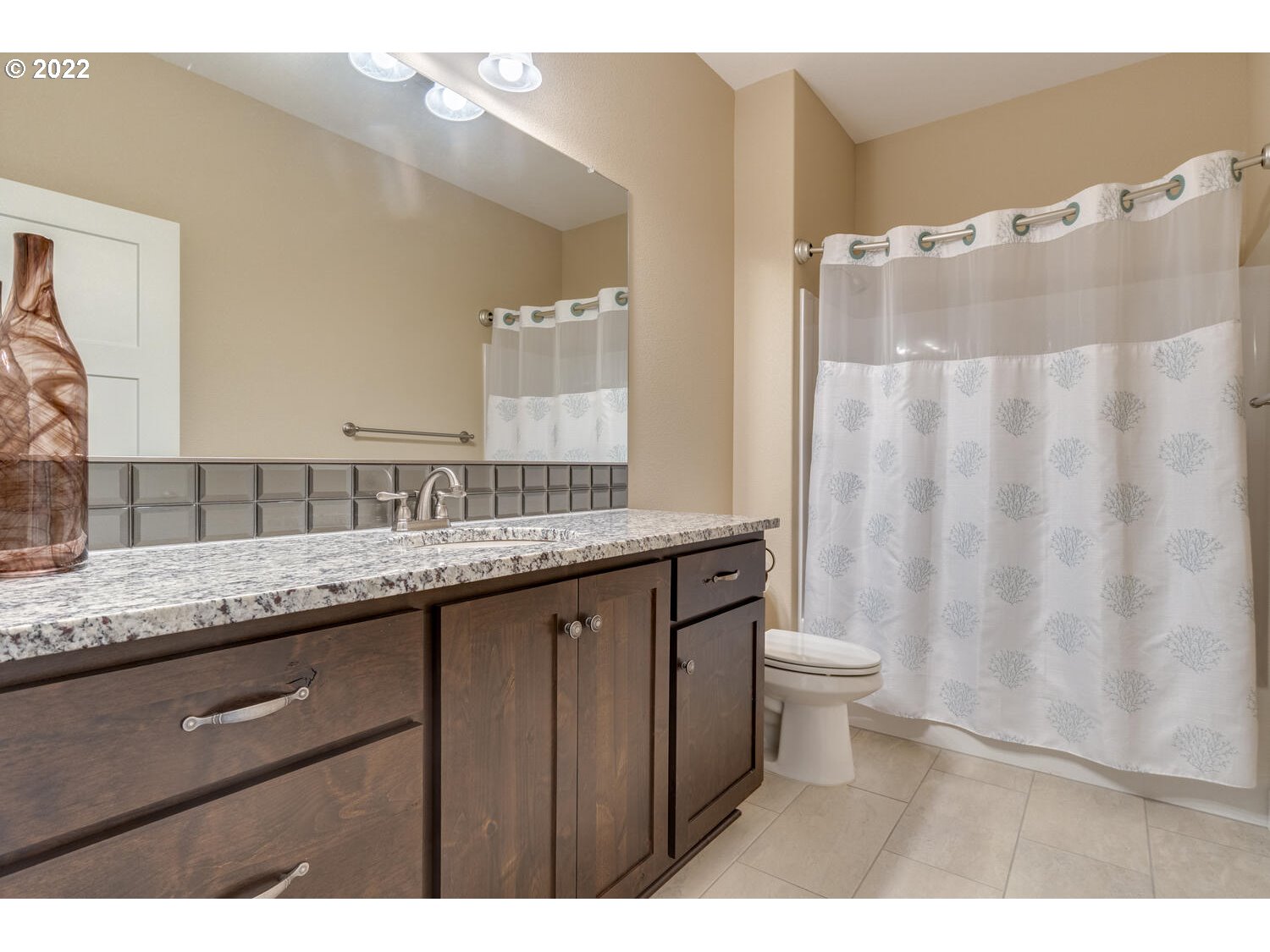 4326 South 11th Way Ridgefield, WA 98642 - Photo 9 of 26 a bathroom with a granite countertop sink and a mirror
