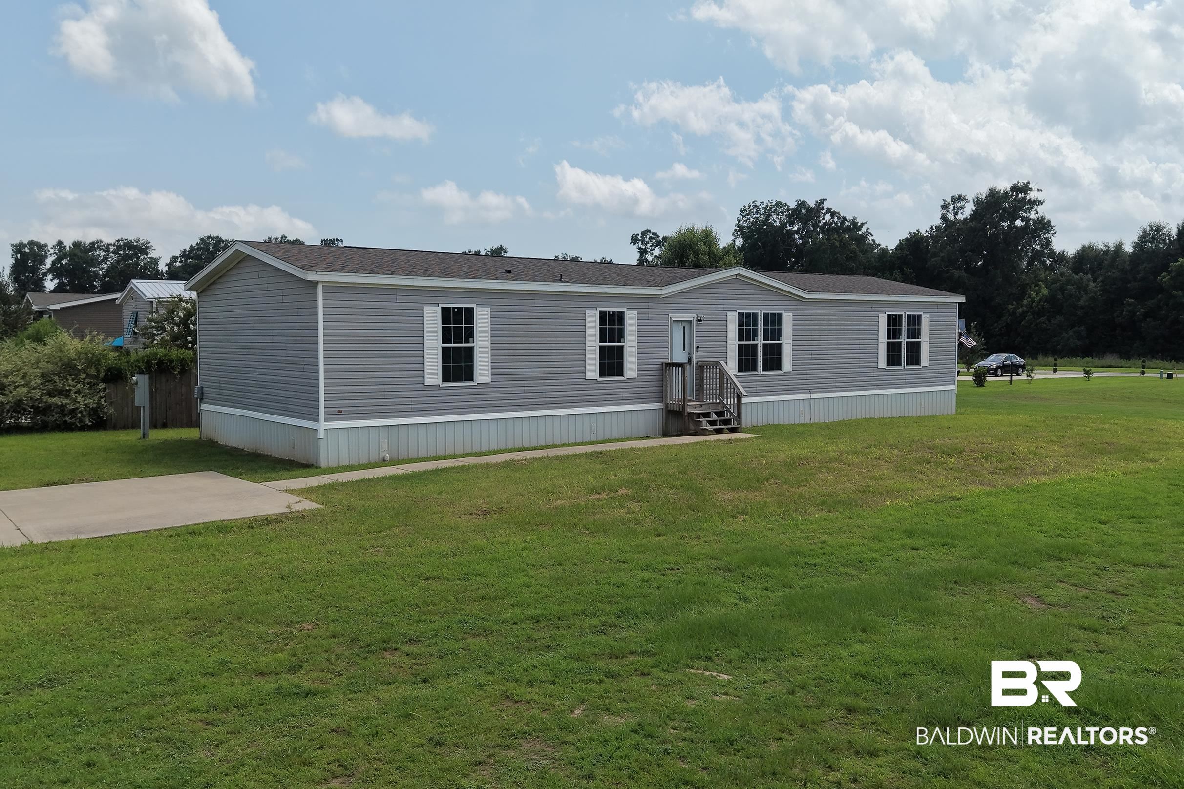 21601 Westside Loop Silverhill, AL 36576 - Photo 2 of 42 Single-story residence featuring gray horizontal siding and a dark shingle roof