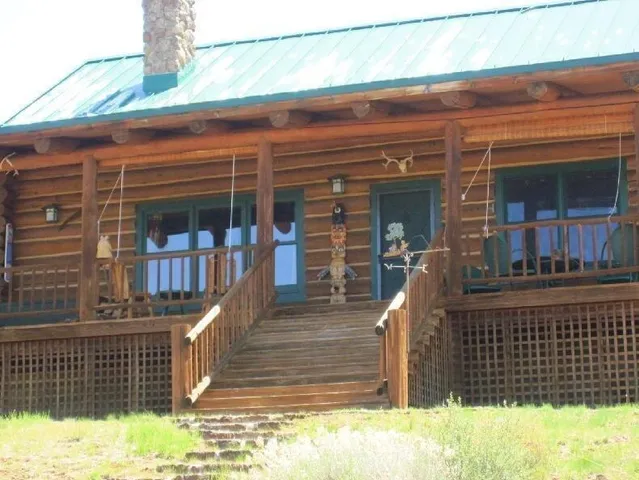 a view of a lake with table and chairs