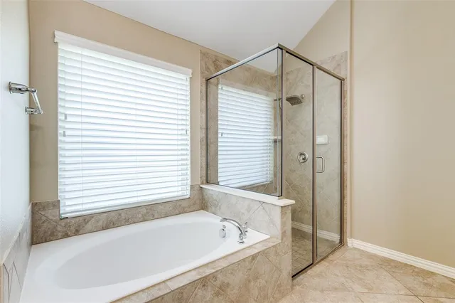 a bathroom with a bathtub and a shower