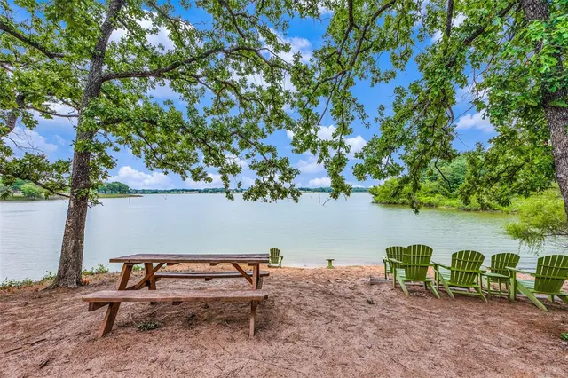 a wooden bench sitting in the backyard of a house