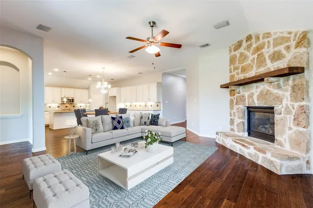 a living room with furniture fireplace and dining table