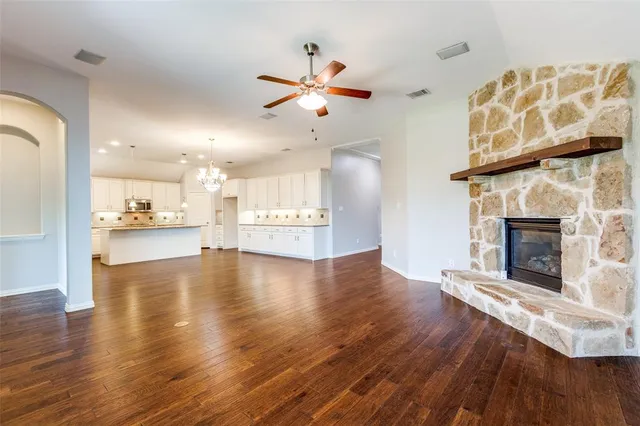 a view of a kitchen with a fireplace and wooden floor