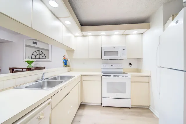 a kitchen with cabinets appliances and a sink