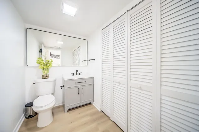 a bathroom with a toilet a sink and a mirror