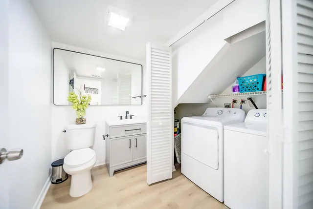 a bathroom with a sink a toilet and a mirror