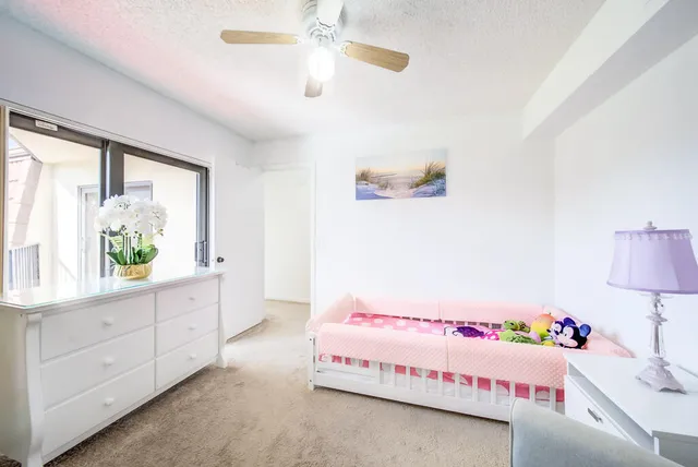 a bedroom with a bed and a potted plant
