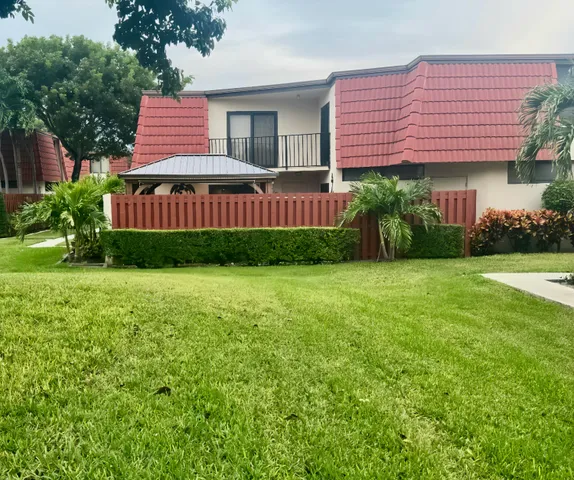 a front view of a house with yard and green space