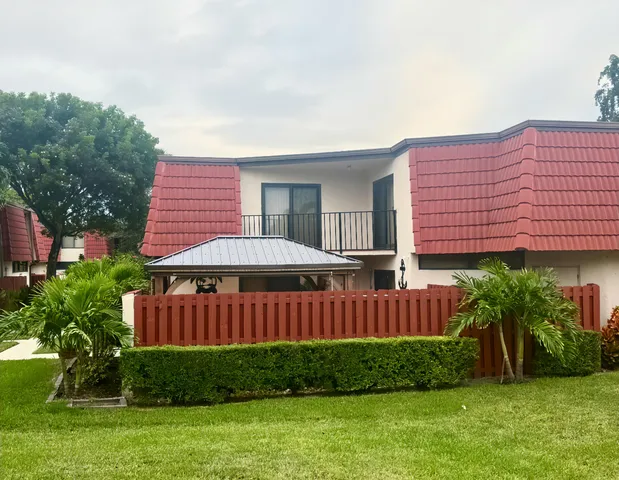 a view of a house with a yard and sitting area