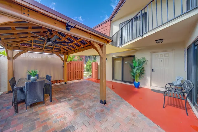 a view of swimming pool with a patio and plants
