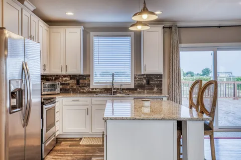 a bedroom with a large bed and a ceiling fan