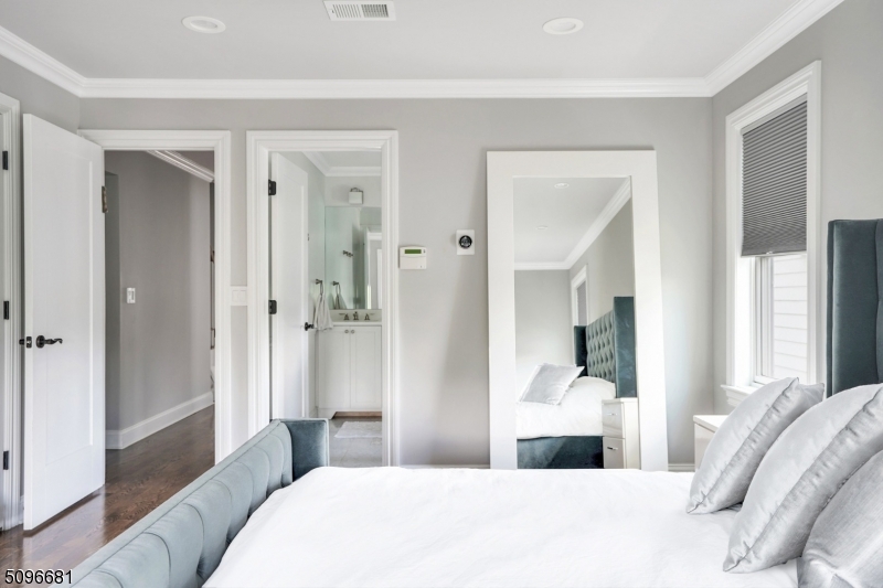 17 Spring Street Millburn, NJ 07041 - Photo 11 of 16 a bedroom with a bed and a mirror