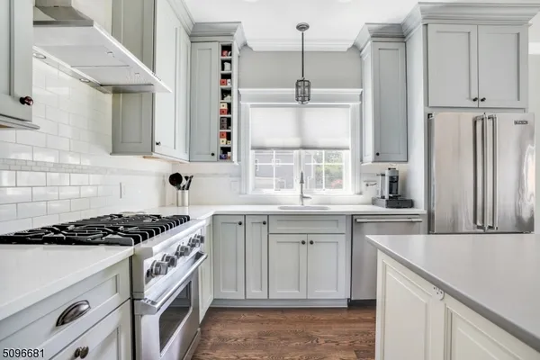 a kitchen with granite countertop a sink stove and cabinets