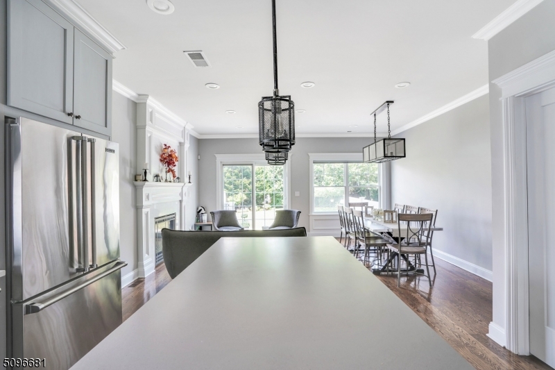 17 Spring Street Millburn, NJ 07041 - Photo 6 of 16 a kitchen with stainless steel appliances granite countertop a refrigerator and a view of living room