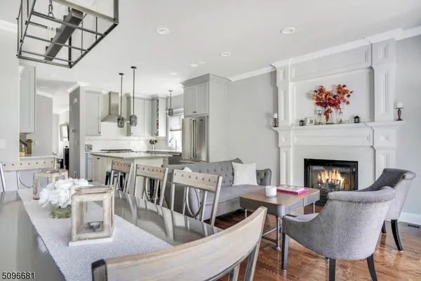 a living room with furniture a fireplace and a chandelier
