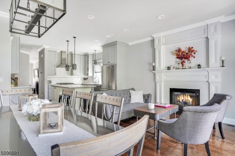 17 Spring Street Millburn, NJ 07041 - Photo 8 of 16 a living room with furniture a fireplace and a chandelier
