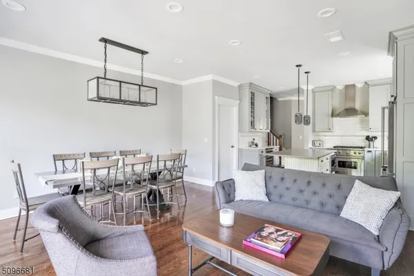 a living room with furniture and a view of kitchen