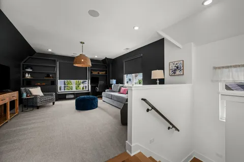 a living room with furniture and kitchen view