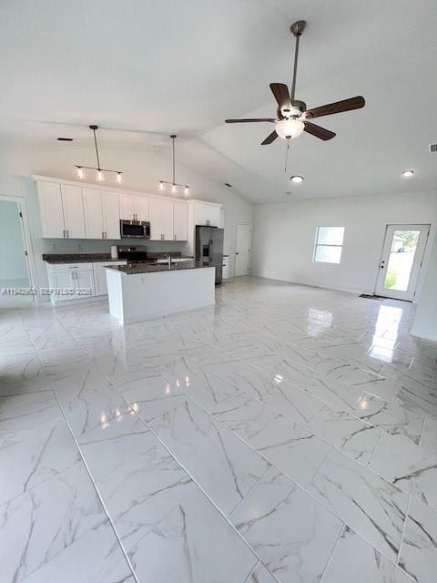 475 Sunset Road North Rotonda West, FL 33947 - Photo 5 of 17 a view of a kitchen with kitchen island a counter top space appliances and cabinets