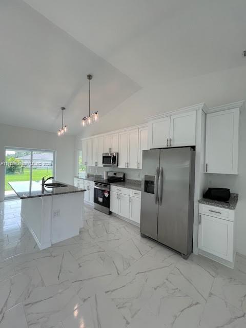 475 Sunset Road North Rotonda West, FL 33947 - Photo 6 of 17 a kitchen with refrigerator and cabinets
