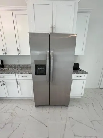 a kitchen with a stove top oven and cabinets
