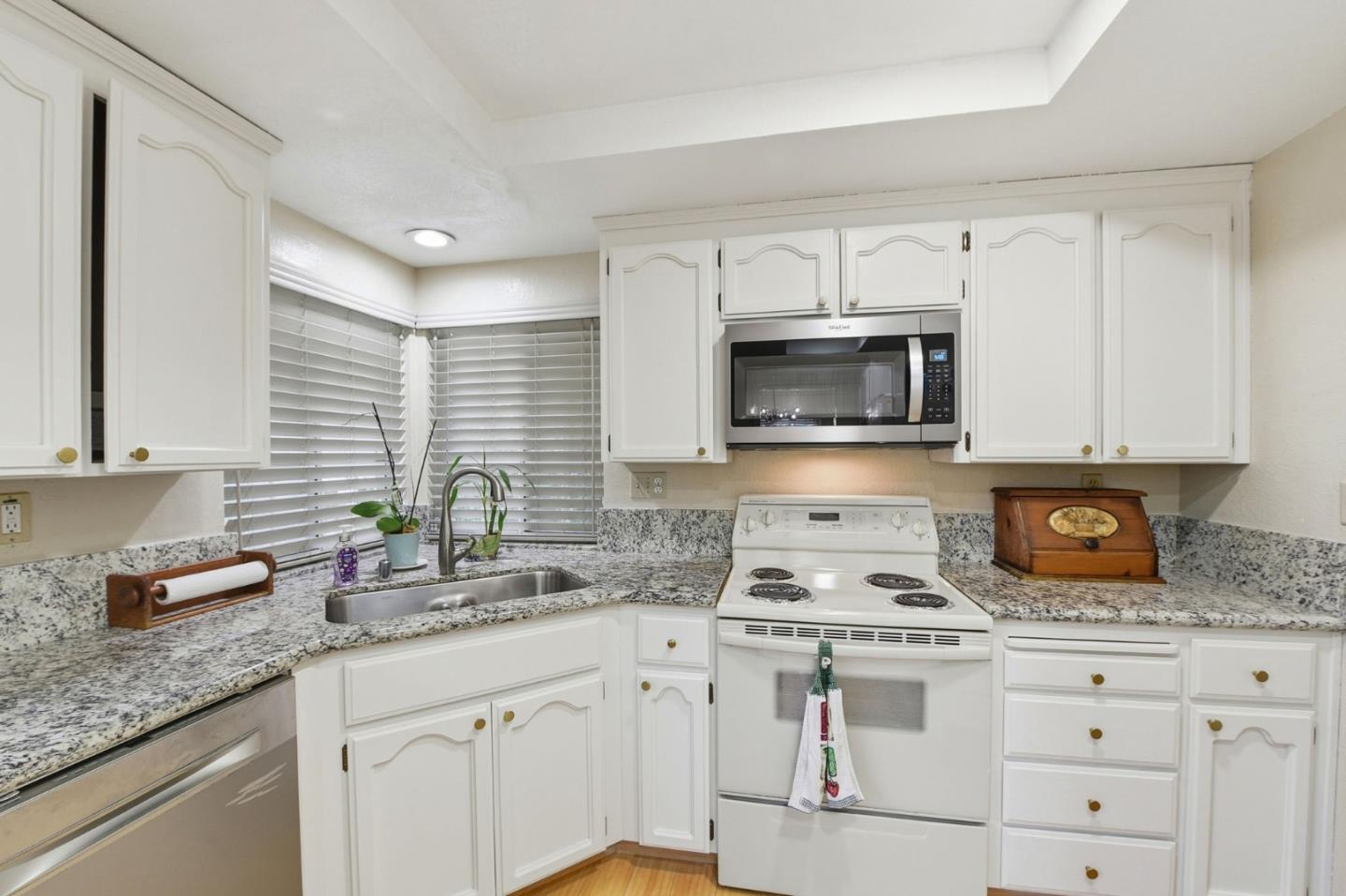 2291 Farmcrest Street Milpitas, CA 95035 - Photo 9 of 36 a kitchen with granite countertop white cabinets and a stove