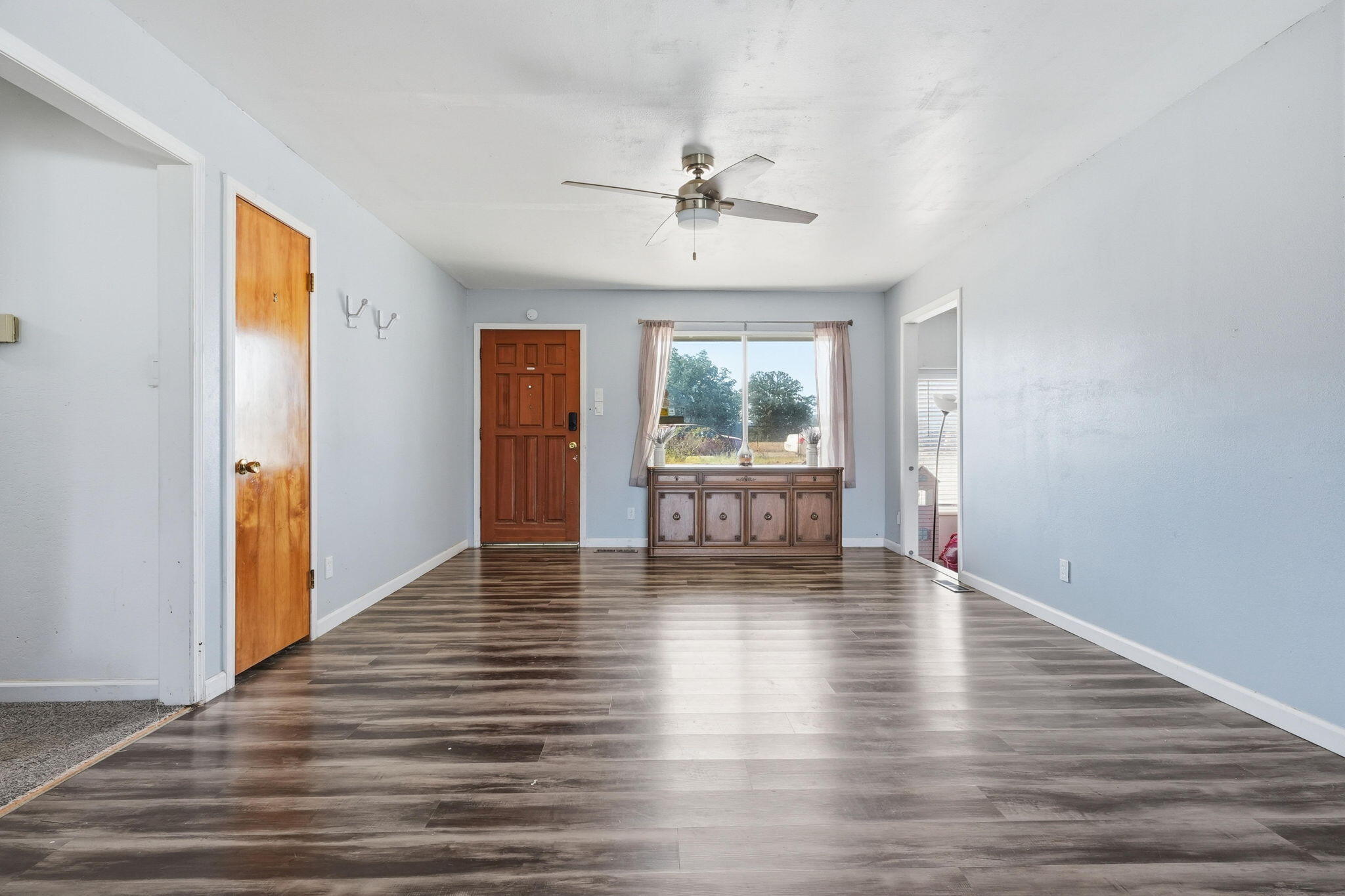 22189 Old Alturas Road Redding, CA 96003 - Photo 13 of 70 a view of an empty room with wooden floor and a window