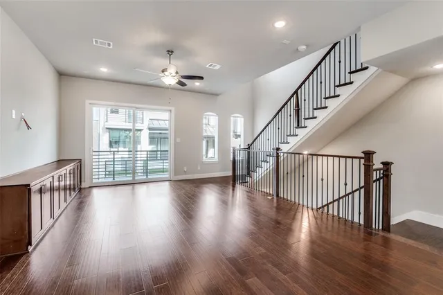 a kitchen with stainless steel appliances granite countertop a refrigerator a sink dishwasher a stove and a refrigerator with wooden floor