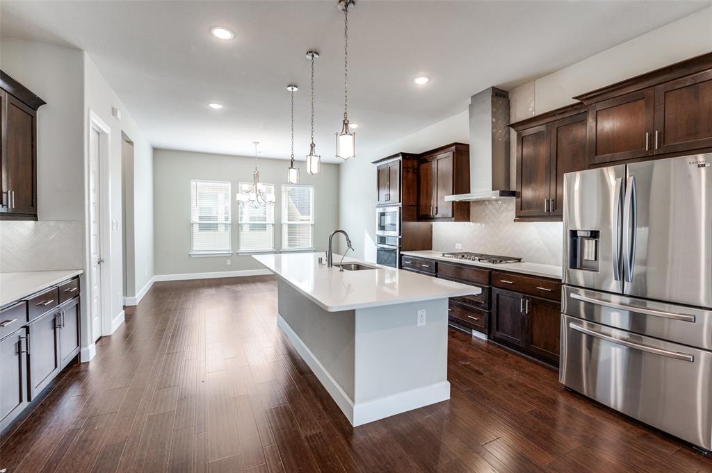 8233 Laflin Lane Dallas, TX 75231 - Photo 15 of 37 a kitchen with stainless steel appliances granite countertop a refrigerator a sink dishwasher a stove and a refrigerator with wooden floor