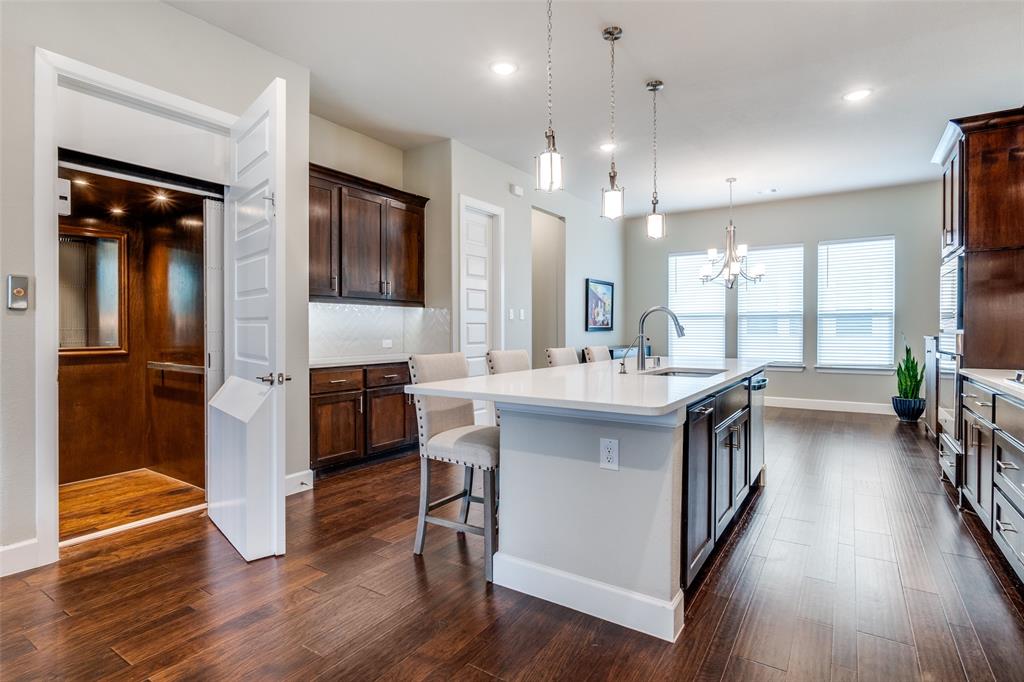 8233 Laflin Lane Dallas, TX 75231 - Photo 19 of 37 a bathroom with a sink a mirror and a shower