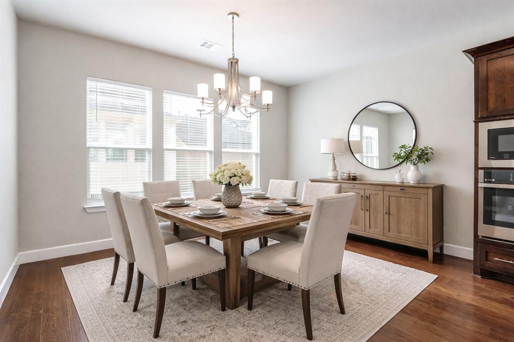 8233 Laflin Lane Dallas, TX 75231 - Photo 20 of 37 a dining room with furniture a chandelier and wooden floor