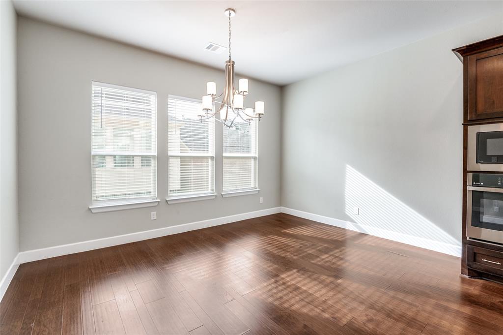 8233 Laflin Lane Dallas, TX 75231 - Photo 21 of 37 a view of an empty room with wooden floor and a window
