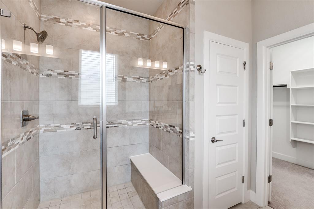 8233 Laflin Lane Dallas, TX 75231 - Photo 29 of 37 a bathroom with a glass shower door and a sink