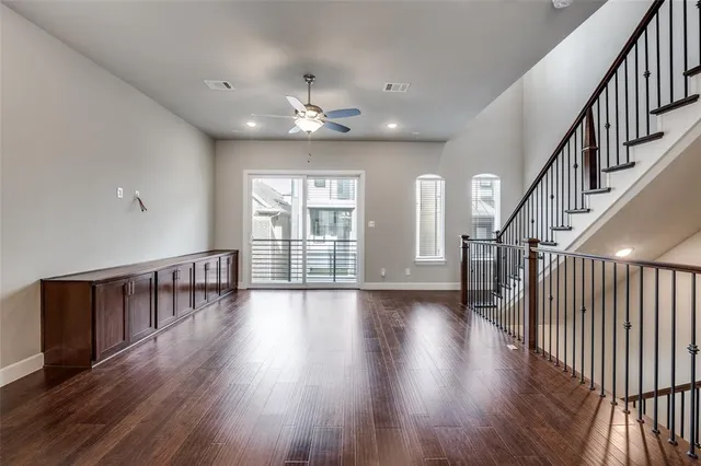 a view of a hallway with wooden floor and workspace