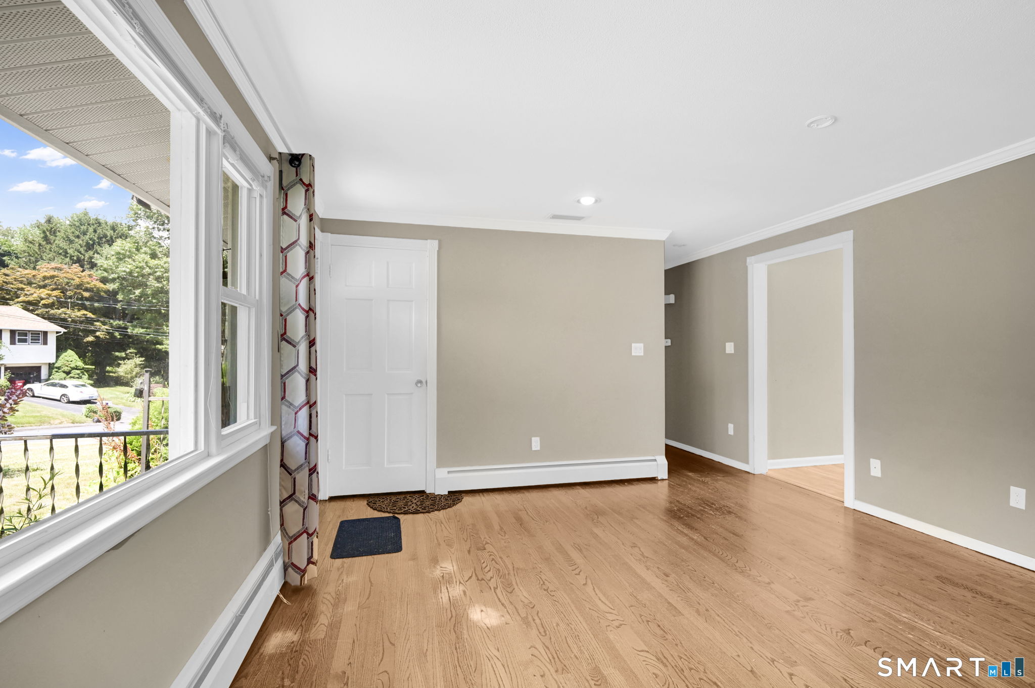 7 Rogers Drive Meriden, CT 06450 - Photo 9 of 40 an empty room with wooden floor and windows
