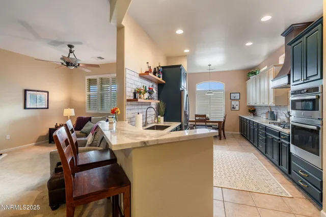 a kitchen with stainless steel appliances kitchen island granite countertop a sink and cabinets