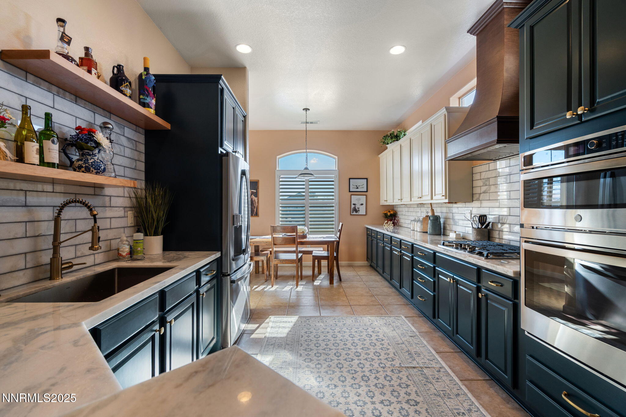 9900 Wilbur May Parkway, Unit 906 Reno, NV 89521 - Photo 2 of 45 a large kitchen with stainless steel appliances granite countertop a stove a sink dishwasher a dining table and chairs with wooden floor