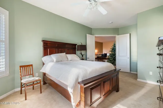 a bed room with a bed and a chair